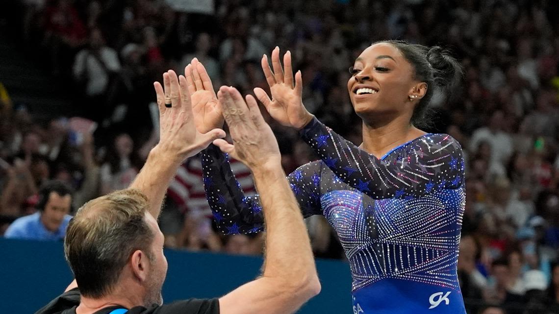 Why do Team USA gymnasts wear different color leotards in the same event?