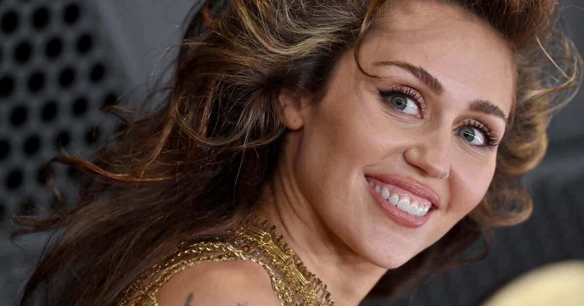 Fans Say Miley Cyrus 'Served' Looks in Plunging Black Mini Dress With Toned Legs on Display
