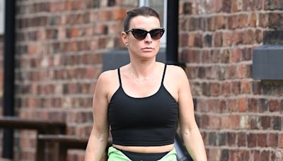 Coleen Rooney flashes a glimpse of her toned abs in a black crop top