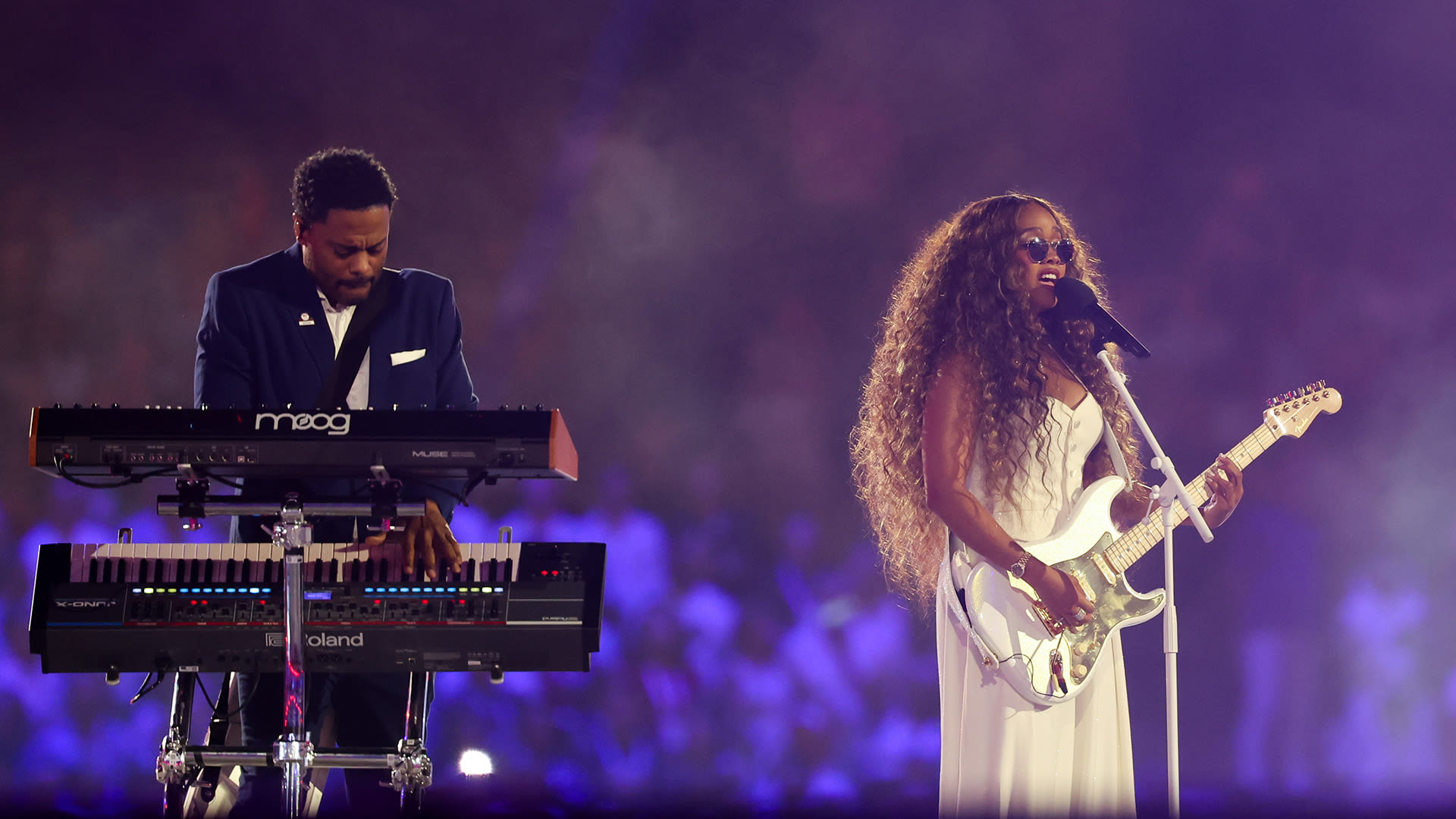 H.E.R. performs national anthem – and solos as Tom Cruise abseils into the stadium – at the Olympics closing ceremony