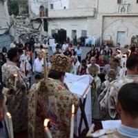 A Palestinian Orthodox Christian priest guides Easter mass for the minority community in Gaza, outside the Church of Saint Porphyrius in Gaza City