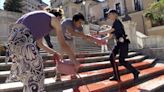 Activists pour red paint down Rome's famed Spanish Steps in outrage over femicides in Italy