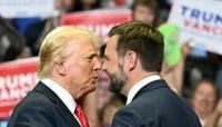 Republican nominee Donald Trump, wearing a new bandage on his ear after an attempted assassination, greets running mate J.D. Vance at a rally in Grand Rapids, Michigan