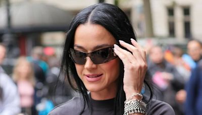 Katy Perry covers up in a quirky black ensemble as she heads to radio