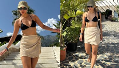 Tripti Dimri soaks in the tropical sun looking fiery in a black bikini paired with white wrap skirt