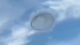 Mysterious 'ring-shaped UFO' seen hiding in clouds in broad daylight