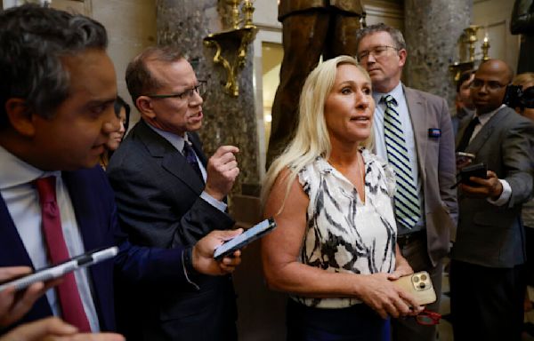 Rep. Marjorie Taylor Greene huddles with U.S. House speaker she’s trying to oust