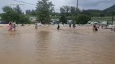 Dollywood patrons wade through knee-deep water as theme park floods