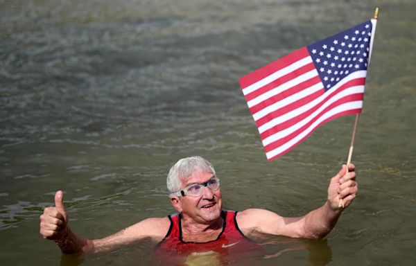 An American swims in Paris' Seine River before the Olympics despite contamination concerns