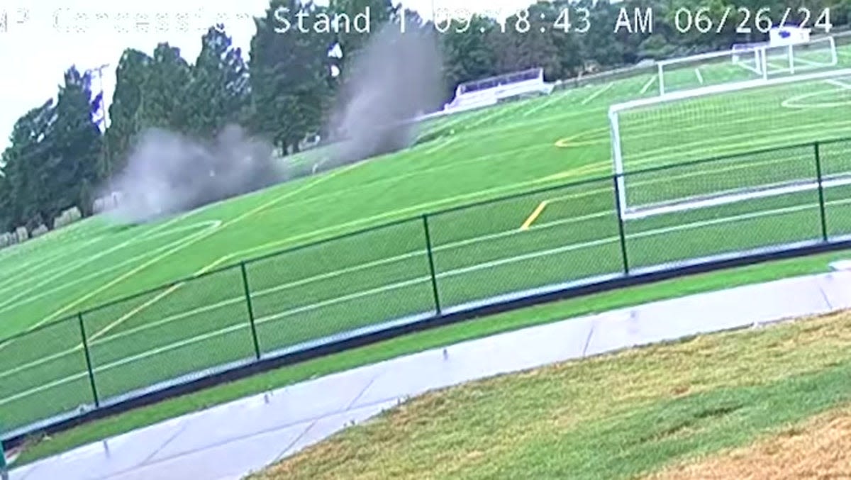 Moment 100-foot-wide sinkhole opens up and collapses Illinois football field