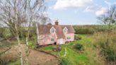 Detached cottage with several outbuildings for sale at £500,000