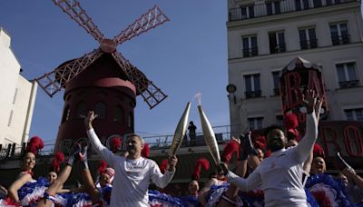 Artists, chefs, garbage collector among hundreds carrying the Olympic torch through Paris