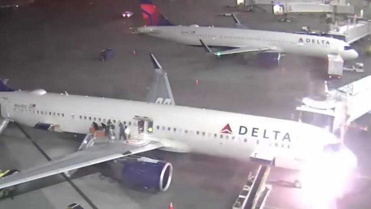 Passengers flee down emergency slides as Delta plane catches fire on airport tarmac