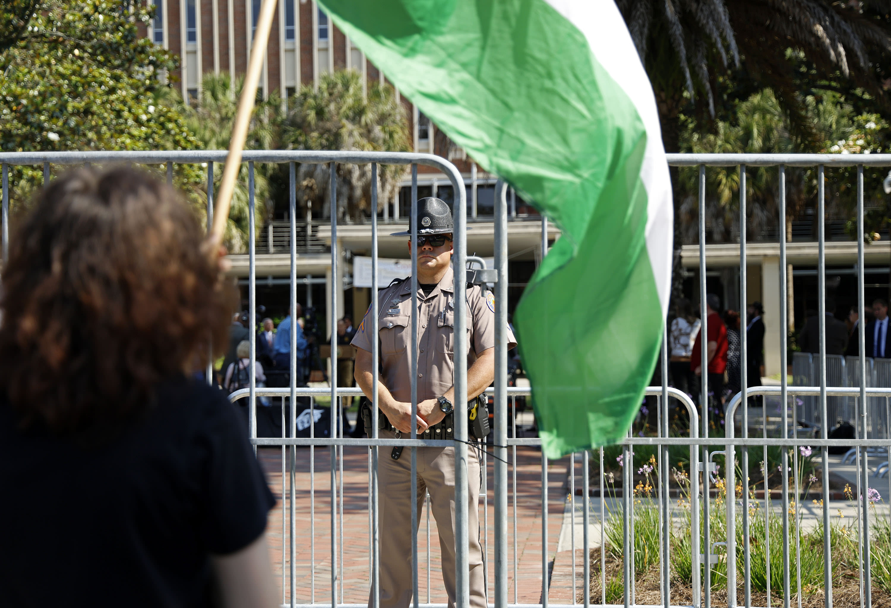 DeSantis lauds law enforcement and universities at a UF press conference as protesters demonstrate