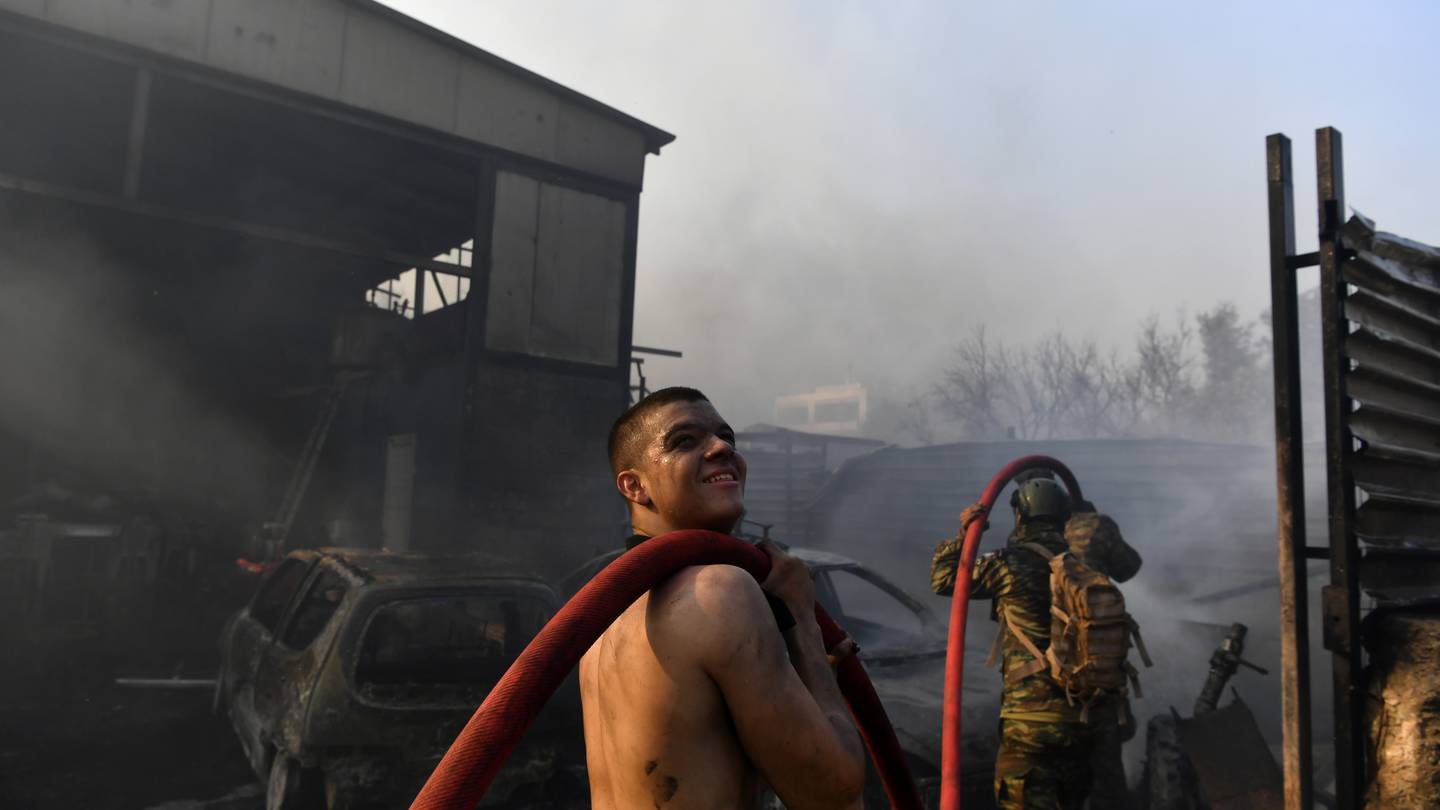 Drop in winds offers hope as Greek firefighters battle huge wildfire scorching the fringes of Athens