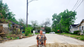 Houston man stands in deep pothole to get city's attention