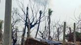 A woman walks past her temporary house following fighting between Myanmar's military and the Arakan Army