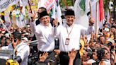 Indonesian presidential candidates register for next year's elections as supporters cheer