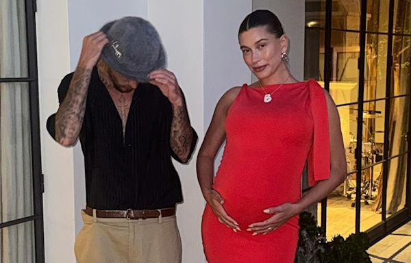 Pregnant Hailey Bieber Cradles Her Baby Bump in Ruby Red Frock With Justin Bieber