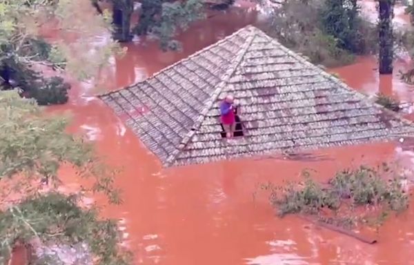 Residents rescued from rooftops following mass floods in Brazil