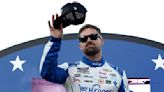 ...Icy Hot Chevrolet, waves to fans as he walks onstage during driver intros prior to the NASCAR Cup Series All-Star Race at North Wilkesboro Speedway on...