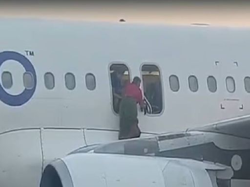 IndiGo bomb threat: Dramatic videos show woman walking on wing, passengers evacuating using slide at Delhi airport – Watch