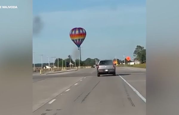 Hot air balloon strikes power lines, burning pilot and 2 passengers