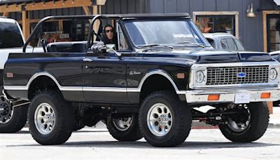 Kourtney Kardashian slips into driver's seat of classic Chevy K5 Blazer truck for Calabasas coffee run as husband Travis Barker rides shotgun