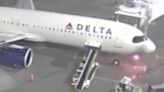 Moment Delta plane catches fire as passengers flee down emergency exit