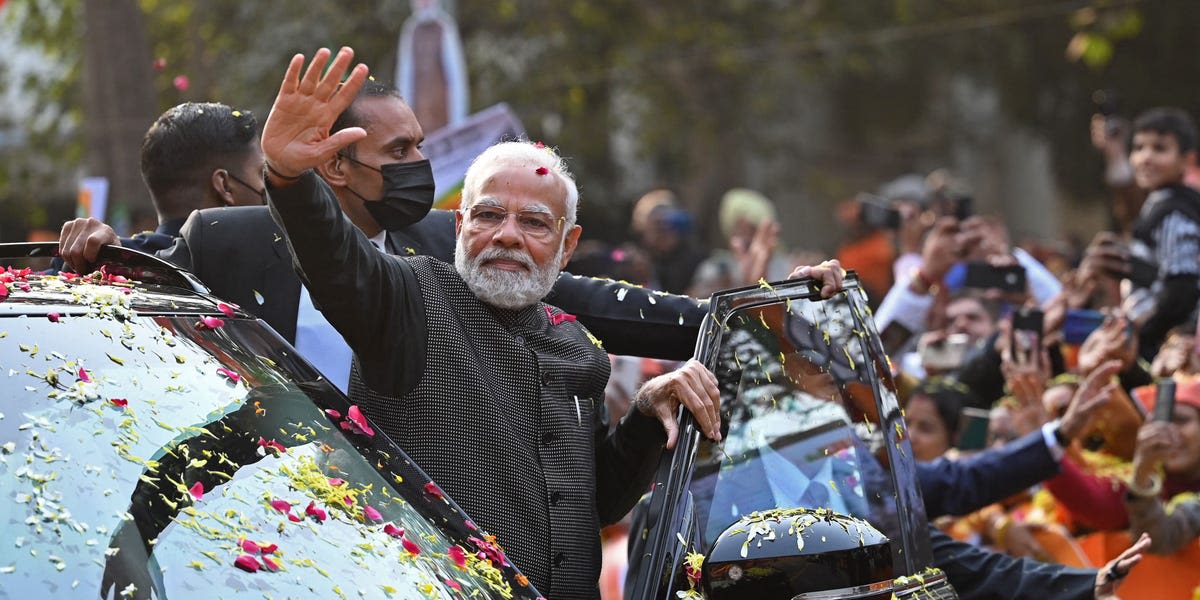 Indian PM Modi steals limelight at lavish Ambani wedding as route to the ceremony lined with posters