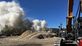 Large fire burning in debris pile at wood recycling plant in St. Johns neighborhood