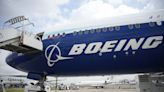 Boeing names its next CEO while posting a quarterly loss of more than $1.4 billion