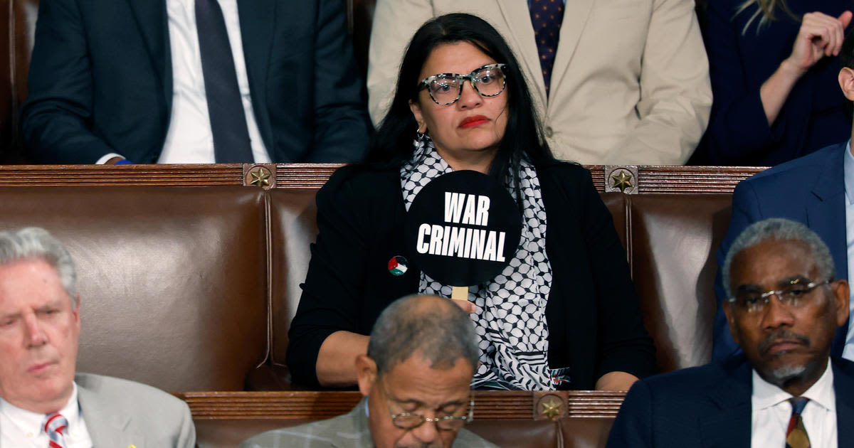 Rep. Rashida Tlaib holds "war criminal" sign during Benjamin Netanyahu's speech to Congress