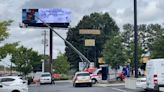 Billboard workers stuck 70 feet in air after equipment malfunction