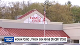 Woman found living in rooftop grocery store sign for nearly a year, Michigan cops say