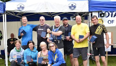 Teams paddle in the rain on The Mere for charity at popular boat regatta