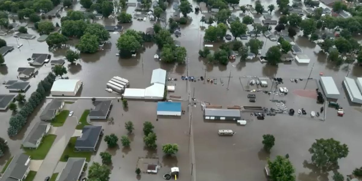 Helicopters scramble to rescue people in flooded Iowa town while much of US toils again in heat