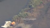 Video appears to show a Russian tank hitting a mine and running out of control before sinking into water