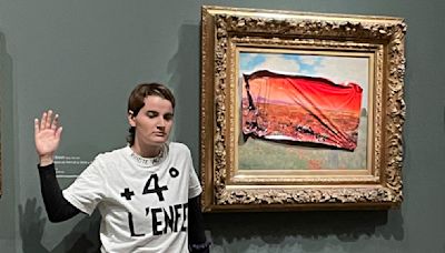 Environmental activist sticks protest poster to Monet's "Poppy Field"