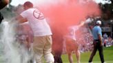 Six climate protesters run onto 18th green and spray powder, delaying finish of PGA Tour event