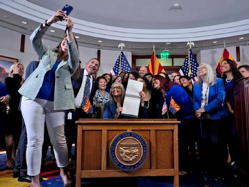 Arizona governor's signing of abortion law repeal follows political fight by women lawmakers