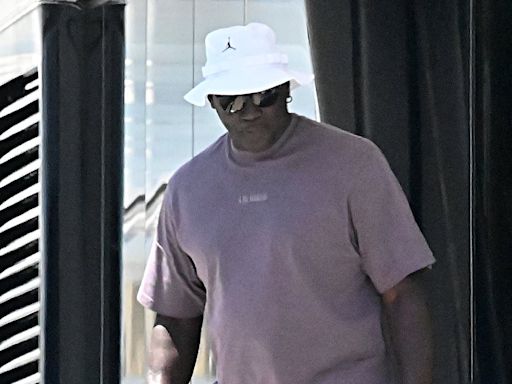 Michael Jordan smokes a cigar as he heads out for dinner in Barcelona