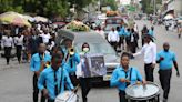 Hundreds mourn gang killings of a Haitian mission director and a young American couple