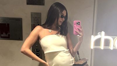 Pregnant Hailey Bieber Shows Off Baby Bump in Chic Cream Look as She Snaps Mirror Selfie: 'Working Hard'