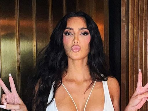 Kim Kardashian turns heads in daring white cut out dress as she reveals her kids are 'sneakily setting her up on dates'