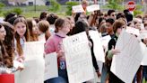 McDowell students walk out of class in silent protest, wearing red and white