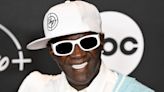 Flavor Flav Reps Taylor Swift '1989' Merch in Stylish Red Carpet Appearance