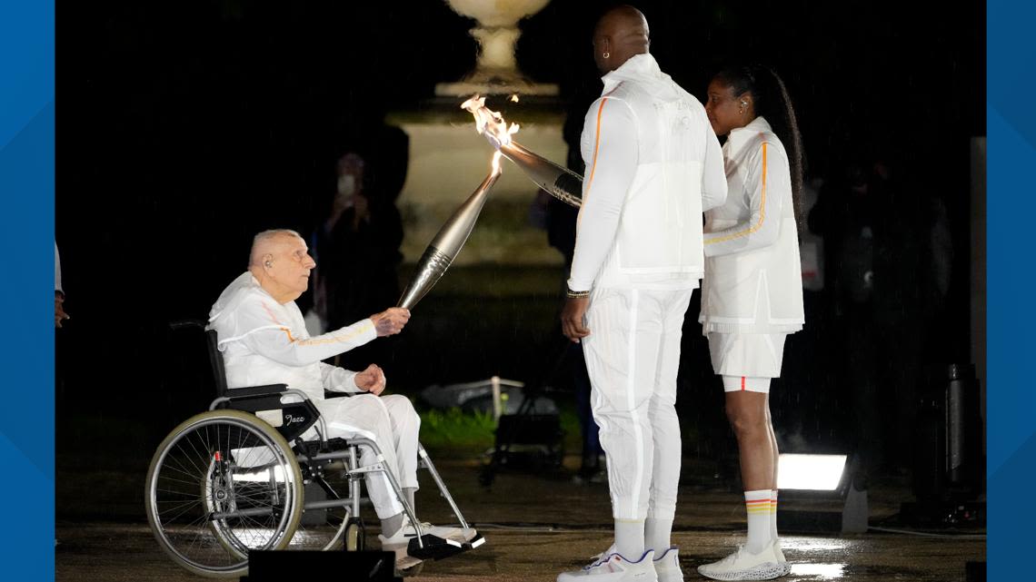 Olympic cauldron lit by French gold medalists Teddy Riner and Marie-José Pérec