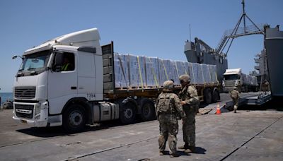 Off Gaza’s coast, truckloads of aid roll off a US military pier – only to remain uncollected