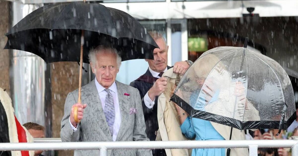 Lip reader on Charles' blunt demand as he helps struggling Camilla in harsh rain